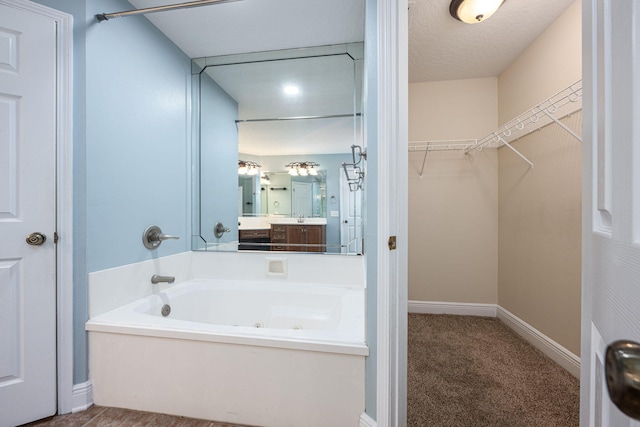 bathroom featuring a textured ceiling and a bathtub