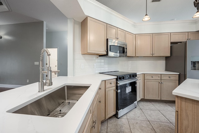 kitchen featuring pendant lighting, appliances with stainless steel finishes, sink, and light brown cabinets