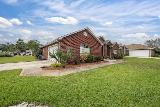 view of front of property with a front yard, central air condition unit, and a garage