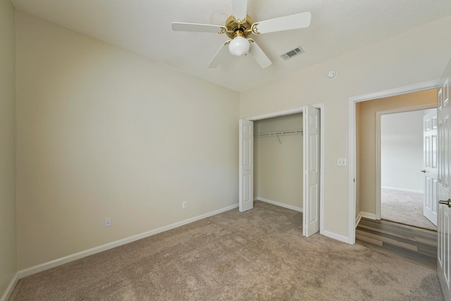 unfurnished bedroom with ceiling fan, a closet, and light colored carpet