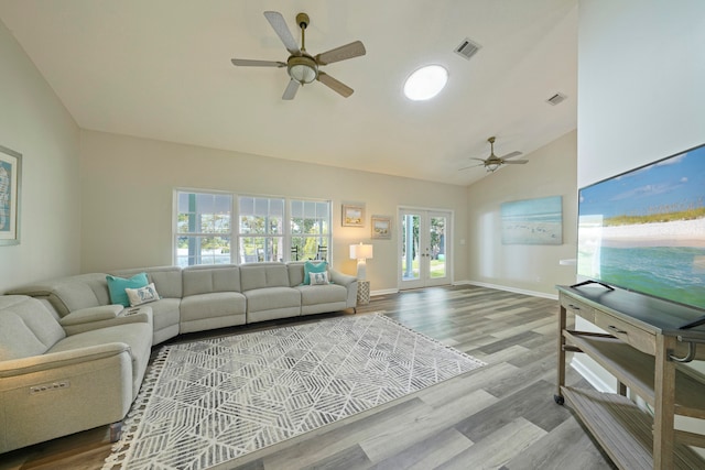 living room with lofted ceiling, french doors, light hardwood / wood-style floors, and ceiling fan