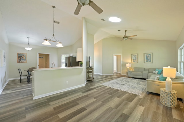 living room with high vaulted ceiling, ceiling fan, and dark hardwood / wood-style flooring