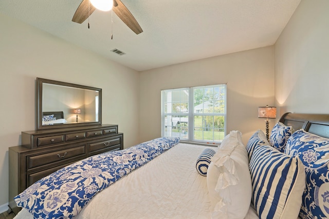 bedroom with ceiling fan and a textured ceiling