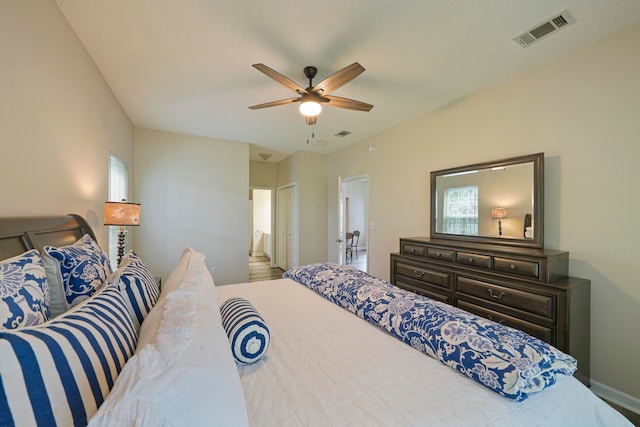 bedroom with ceiling fan, a closet, and ensuite bath