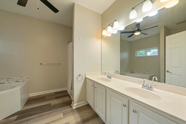 bathroom featuring wood-type flooring, separate shower and tub, vanity, and ceiling fan