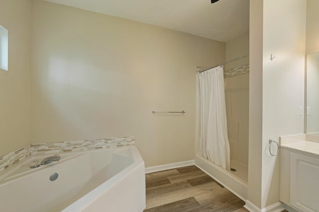 bathroom with vanity, shower with separate bathtub, and hardwood / wood-style floors