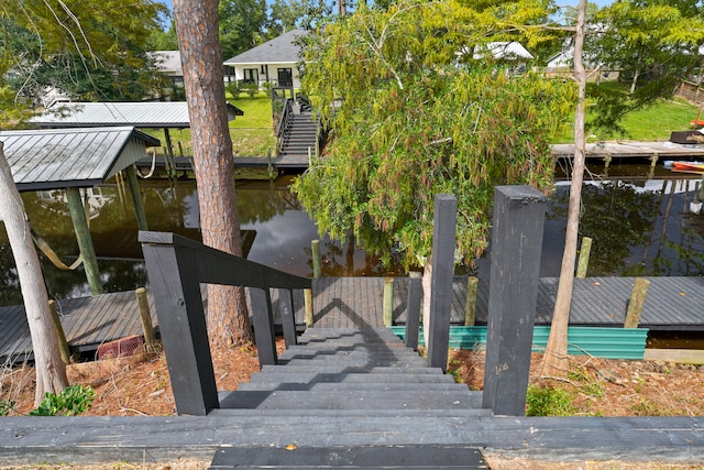 exterior space with a water view and a dock