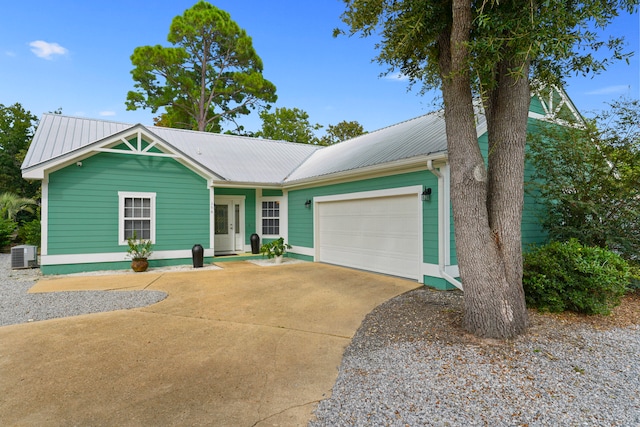 view of front of house featuring central AC unit and a garage