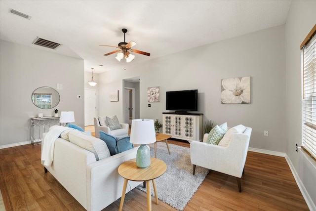 living room featuring ceiling fan and hardwood / wood-style flooring