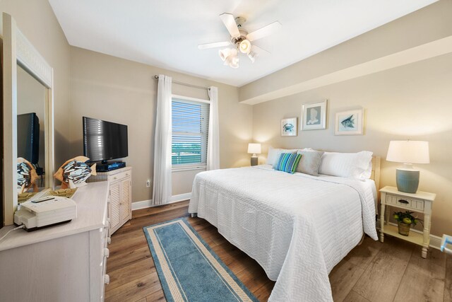 bedroom featuring ceiling fan and dark hardwood / wood-style flooring