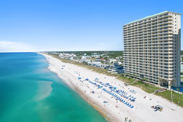 drone / aerial view with a beach view and a water view