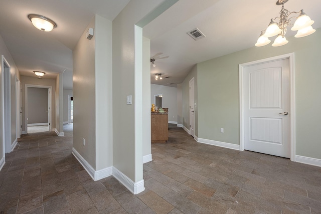 2826 Shoni Dr, Navarre, FL 32566 - hallway with stone tile flooring, baseboards, visible vents, and an inviting chandelier