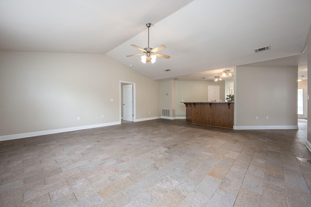 unfurnished living room featuring vaulted ceiling and ceiling fan