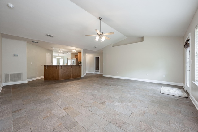 unfurnished living room featuring ceiling fan and lofted ceiling