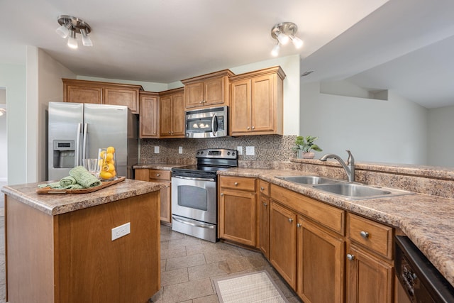 kitchen with decorative backsplash, a center island, stainless steel appliances, and sink