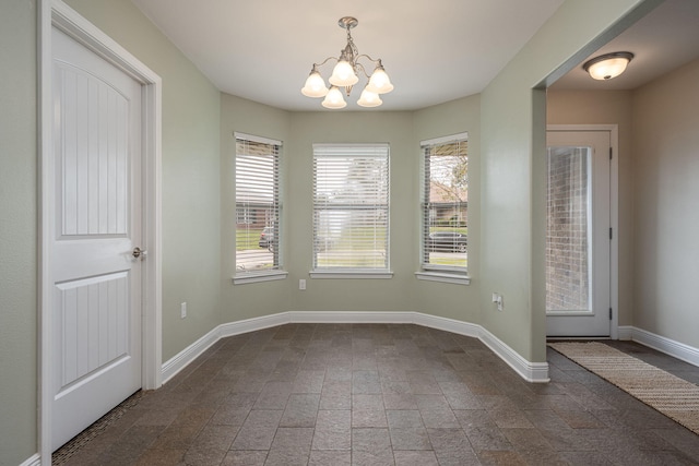 unfurnished dining area featuring an inviting chandelier