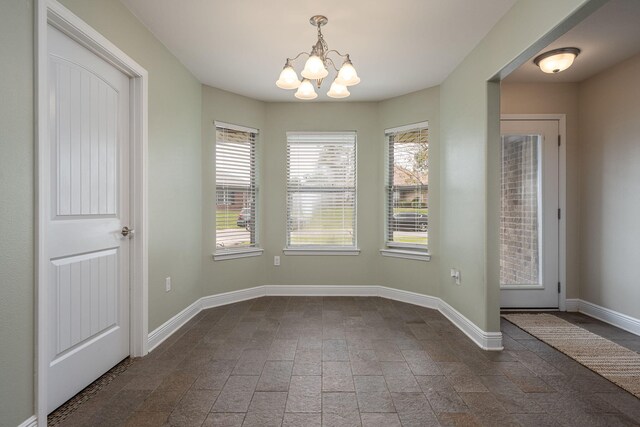 2826 Shoni Dr, Navarre, FL 32566 - unfurnished dining area featuring baseboards and a chandelier