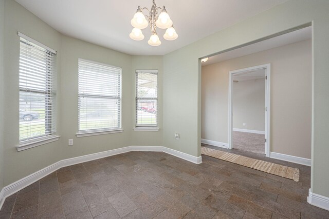 2826 Shoni Dr, Navarre, FL 32566 - spare room featuring an inviting chandelier, baseboards, and plenty of natural light