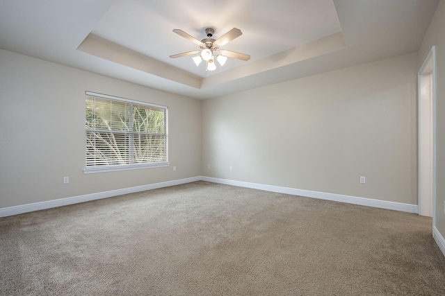 2826 Shoni Dr, Navarre, FL 32566 - empty room featuring baseboards, a ceiling fan, a tray ceiling, and carpet flooring