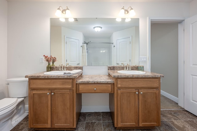 bathroom with toilet, vanity, and walk in shower