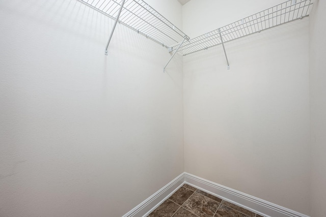 2826 Shoni Dr, Navarre, FL 32566 - spacious closet featuring dark tile patterned flooring