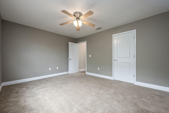 unfurnished bedroom with ceiling fan and carpet floors