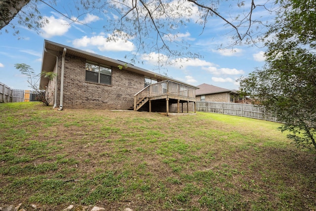 2826 Shoni Dr, Navarre, FL 32566 - rear view of property with a deck, a fenced backyard, stairs, brick siding, and a yard