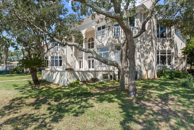 exterior space with a lawn and stucco siding