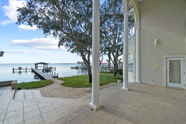 exterior space with a water view, a patio, and a yard