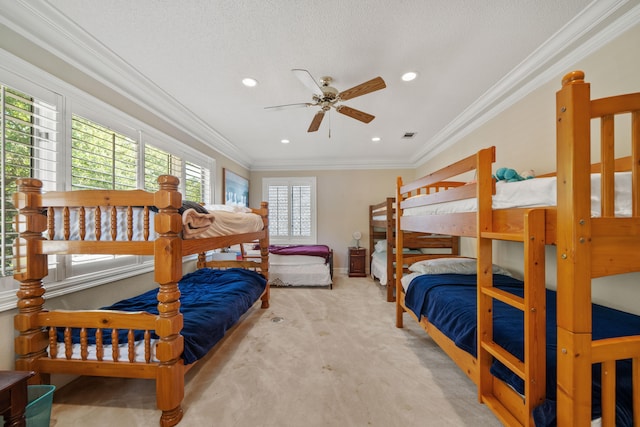 carpeted bedroom with ornamental molding, a textured ceiling, and recessed lighting