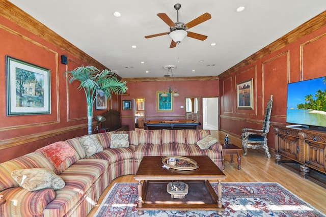 living room with billiards, light wood-style flooring, ornamental molding, a decorative wall, and recessed lighting