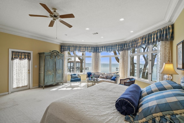 bedroom with ornamental molding, visible vents, a water view, and light carpet