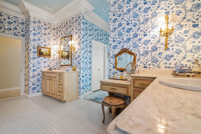 bathroom featuring ornamental molding, two vanities, and wallpapered walls