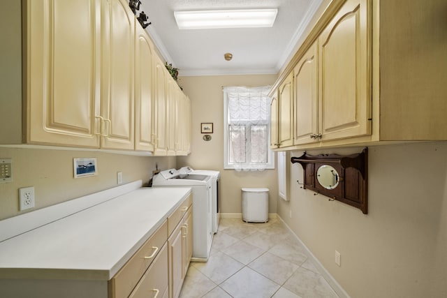 washroom with cabinet space, light tile patterned floors, baseboards, crown molding, and washing machine and dryer