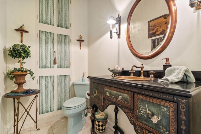 bathroom with vanity, toilet, and tile patterned floors