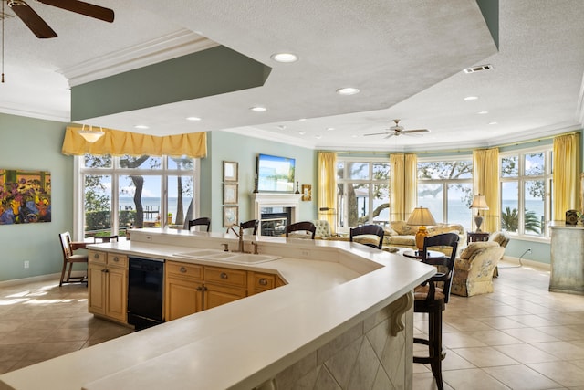 kitchen with crown molding, visible vents, light tile patterned flooring, a sink, and dishwasher