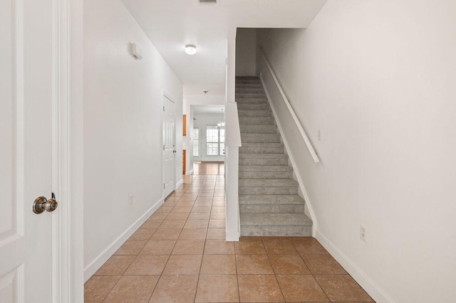 stairs featuring tile patterned floors