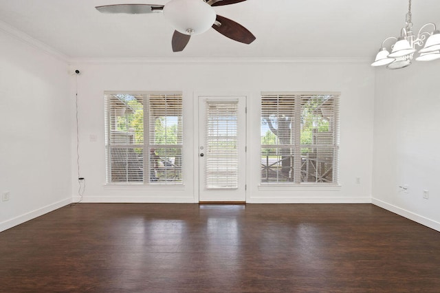 empty room featuring crown molding, ceiling fan with notable chandelier, and dark wood-type flooring