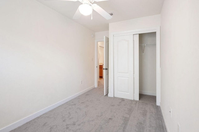 unfurnished bedroom with a closet, ceiling fan, and light colored carpet