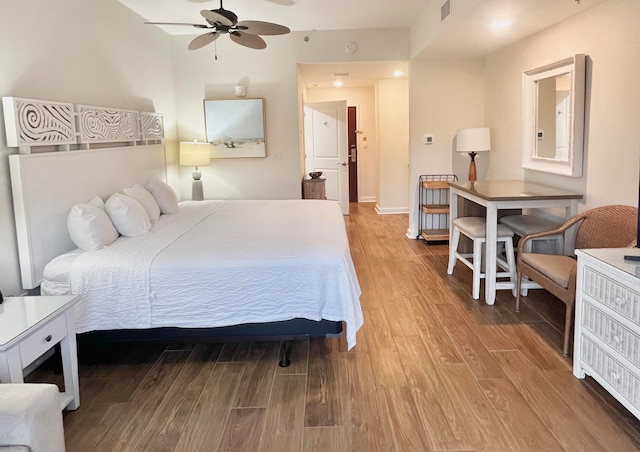 bedroom featuring wood-type flooring and ceiling fan