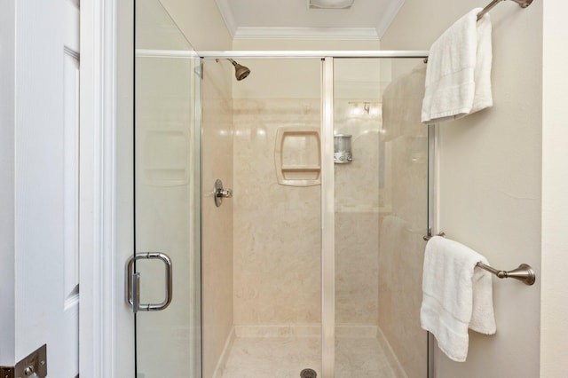 bathroom featuring an enclosed shower and ornamental molding