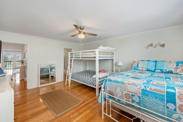 bedroom with ornamental molding, hardwood / wood-style floors, and ceiling fan