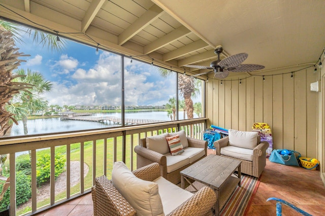 sunroom featuring a water view, ceiling fan, beamed ceiling, and wood ceiling