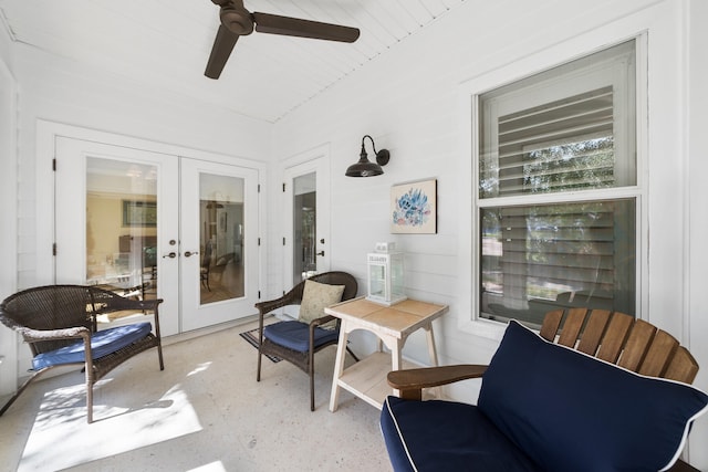 sunroom / solarium featuring french doors and ceiling fan