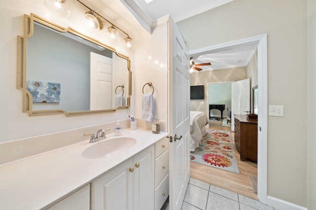 bathroom featuring wood-type flooring, crown molding, vanity, and ceiling fan