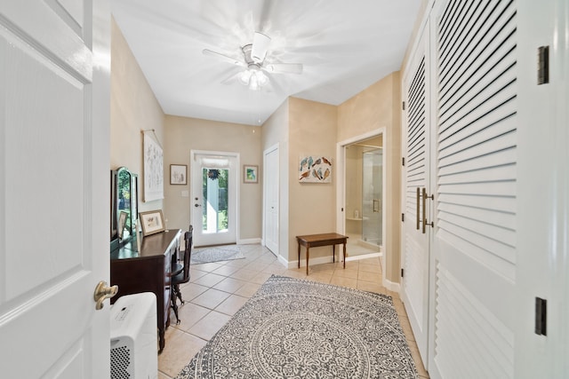 tiled foyer entrance featuring ceiling fan