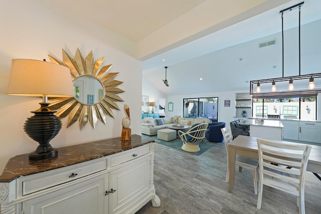 living room featuring lofted ceiling and wood-type flooring