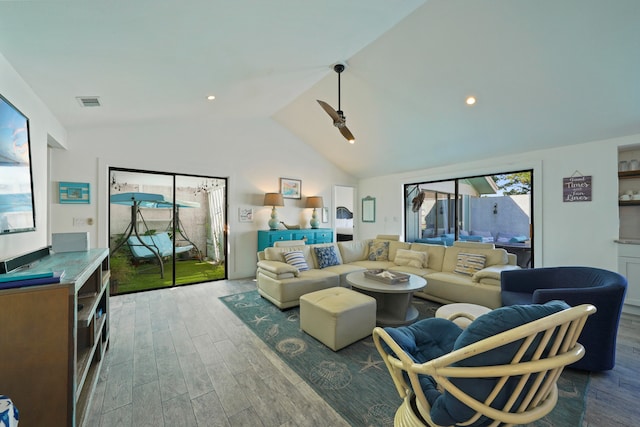 living room featuring vaulted ceiling and hardwood / wood-style flooring