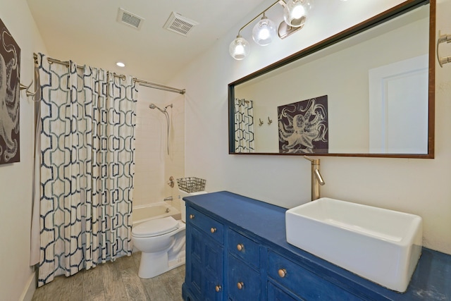 full bathroom with shower / tub combo, hardwood / wood-style floors, vanity, and toilet