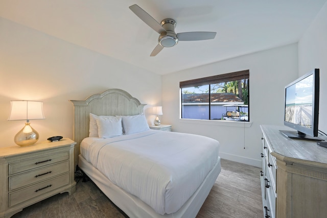 bedroom with ceiling fan and dark hardwood / wood-style floors